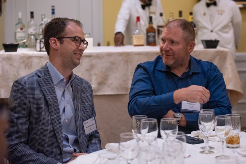 Two attendees in conversation at a table